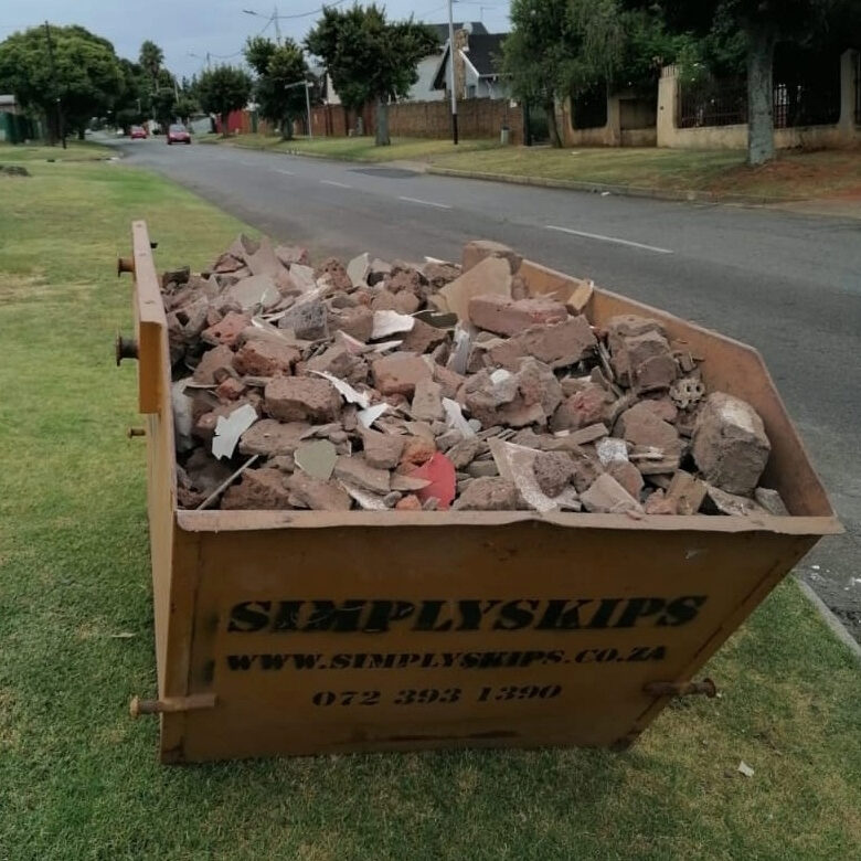 SimplySkips skip bin full of building rubble on a suburban verge in Krugersdorp